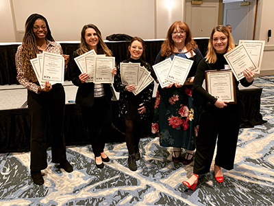 (L-R) JoAnn Weaver, Bridget Christner, Kait Baker, Tammy Merrett and Miranda Lintzenich hold The Alestle staff’s collective IPCA awards.