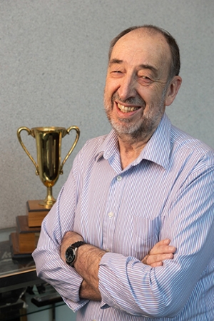 SIUE professor emeritus Luke Snell, PE, stands by the trophy SIUE ACI Student Chapter members won at the first ACI concrete cube competition in 1979.