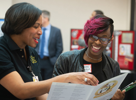 SIUE early childhood education major Jami Gibbs (R) smiles alongside Tracee Wells (L) while learning about the East St. Louis District 189 Urban Education Teacher Residence Program.