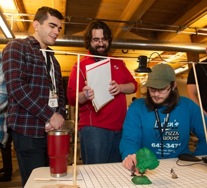 (L-R) Judges Erik Verduim and Matt Lievens are intrigued by the Most Ambitious project created by SIUE’s Dale Auten.