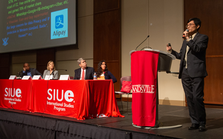 Han Ko, president, founder and CEO of USAKO Group stands at the podium during a panel discussion highlighting businesses with an international focus in the region.