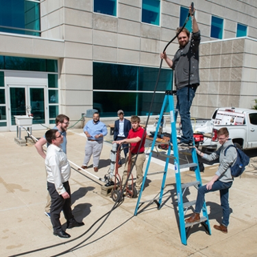 Demonstrating a water hammer pumping water are a team of senior mechanical engineering students.