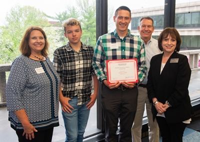 SIUE nursing student and Airman David Lee Jenkins Scholarship recipient Ethan Fields (center) smiles with (L-R) Renee Van Dyke, Ben Jenkins, David Jenkins, and SIUE SON Dean Laura Bernaix.