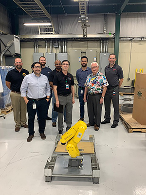 H-J Family of Companies founder and owner Jim Shekelton (front right) stands alongside leaders from the SIUE School of Engineering and representatives from H-J with the donated robotic arm in the foreground. (L-R) Jeffrey Door (H-J), Luis Osorio (H-J