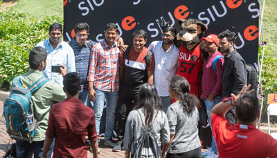SIUE international students have their photo taken with Eddie the Cougar.