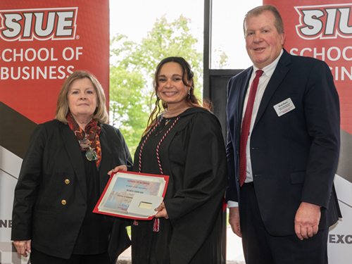 MBA Graduate and SIUE police officer Maria Ferrari poses with Dean Janice Joplin and Interim Assoc Dean Brad Reed 