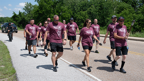 SIUE PD walking torch run with special olympian